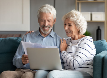 Senior couple together at a laptop